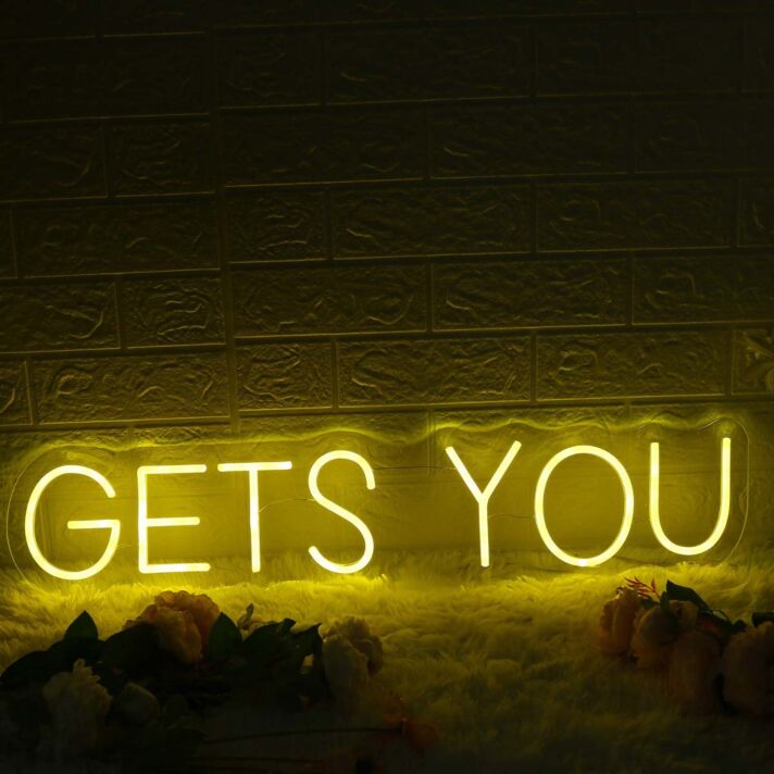 GETS YOU Yellow Neon Sign