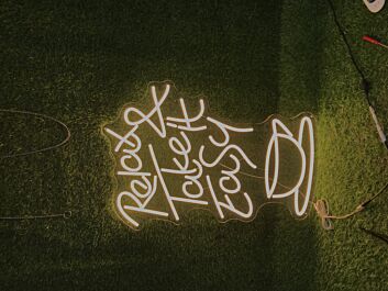 Light Up Your Space with Relax And Take It Easy Yellow LED Neon Sign - Perfect for Home Decor, Office Vibes, and Chill Bar Atmospheres.