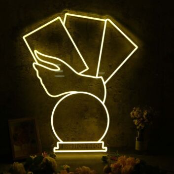Hand Holding Fanned Cards Above a Circle LED Neon Sign