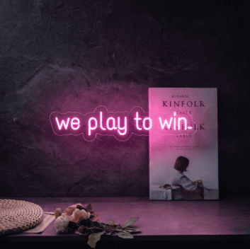 &#39;We play to win&#39; neon sign