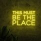 This Must Be the Place Three-Line Yellow Block-Letter LED Neon Sign