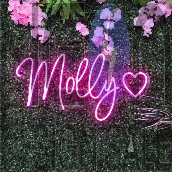 Molly Neon Name Signs Hung On Grass Wall