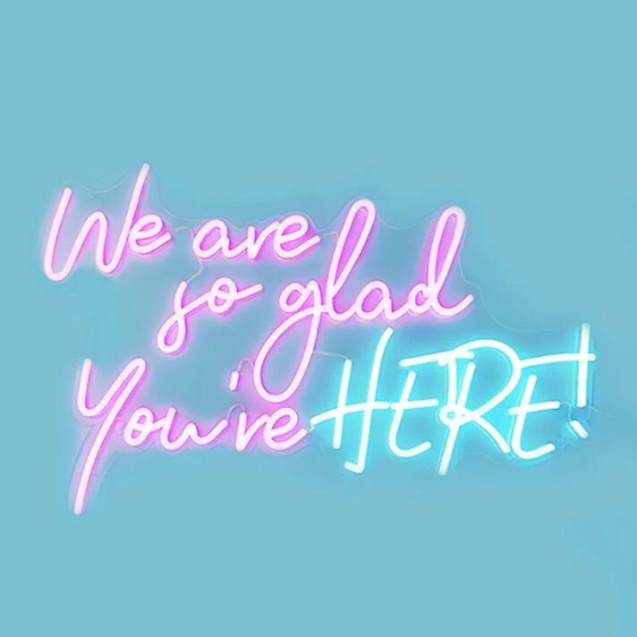 We Are So Glad Youre Here Neon Sign creates a welcoming atmosphere