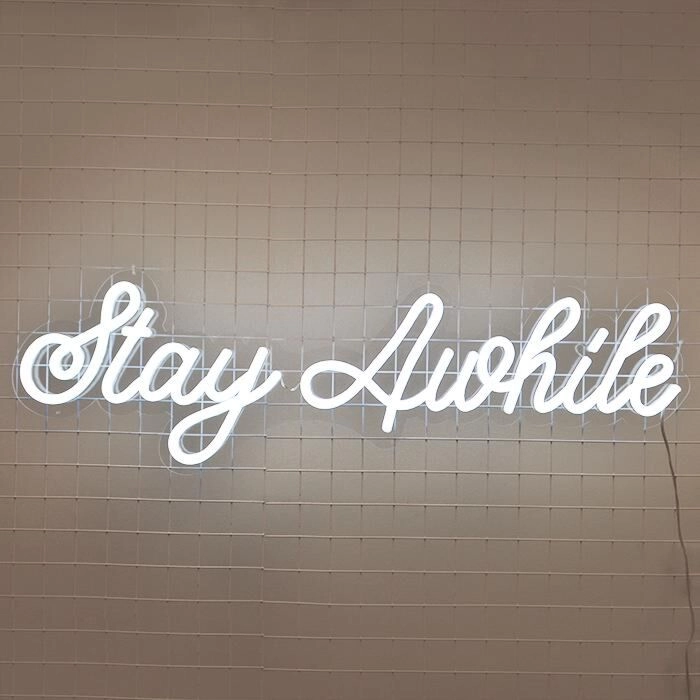 Stay Awhile Neon Sign perfect for cozy living room settings
