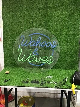 Brighten Up Your Bar, Surf Shop, or Beach House with the Wahoos And Waves Custom Logo LED Neon Sign.