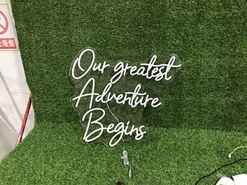 Light Up Your New Chapter: Our Greatest Adventure Begins White LED Neon Sign for Weddings, Home Decor, and Celebratory Events.