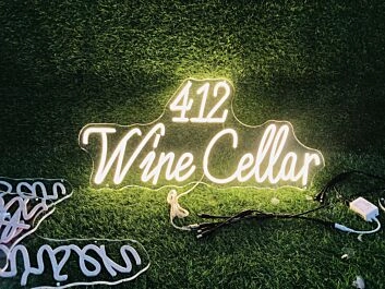 Enhance Your Wine Cellar, Bar, or Wedding Ambiance with the 412 Wine Cellar Yellow Neon Sign.