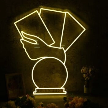 A Hand Holding Books Yellow Neon Sign