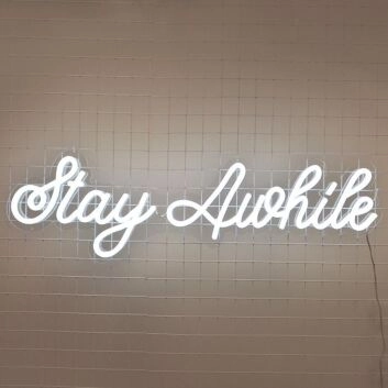 Stay Awhile Neon Sign perfect for cozy living room settings