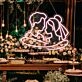 Add a Romantic Glow to Your Bedroom, Wedding, or Anniversary Celebration with the Cuddling Couple Shape Neon Sign.