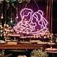 Add a Romantic Glow to Your Bedroom, Wedding, or Anniversary Celebration with the Cuddling Couple Shape Neon Sign.
