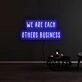 We Are Each Others Business Neon Sign