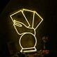 A Hand Holding Books Yellow Neon Sign