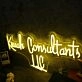 Kruah Consultants LLC Yellow Neon Sign