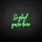 'So glad you're here' neon sign