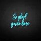 'So glad you're here' neon sign