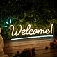 'Welcome 2' neon sign