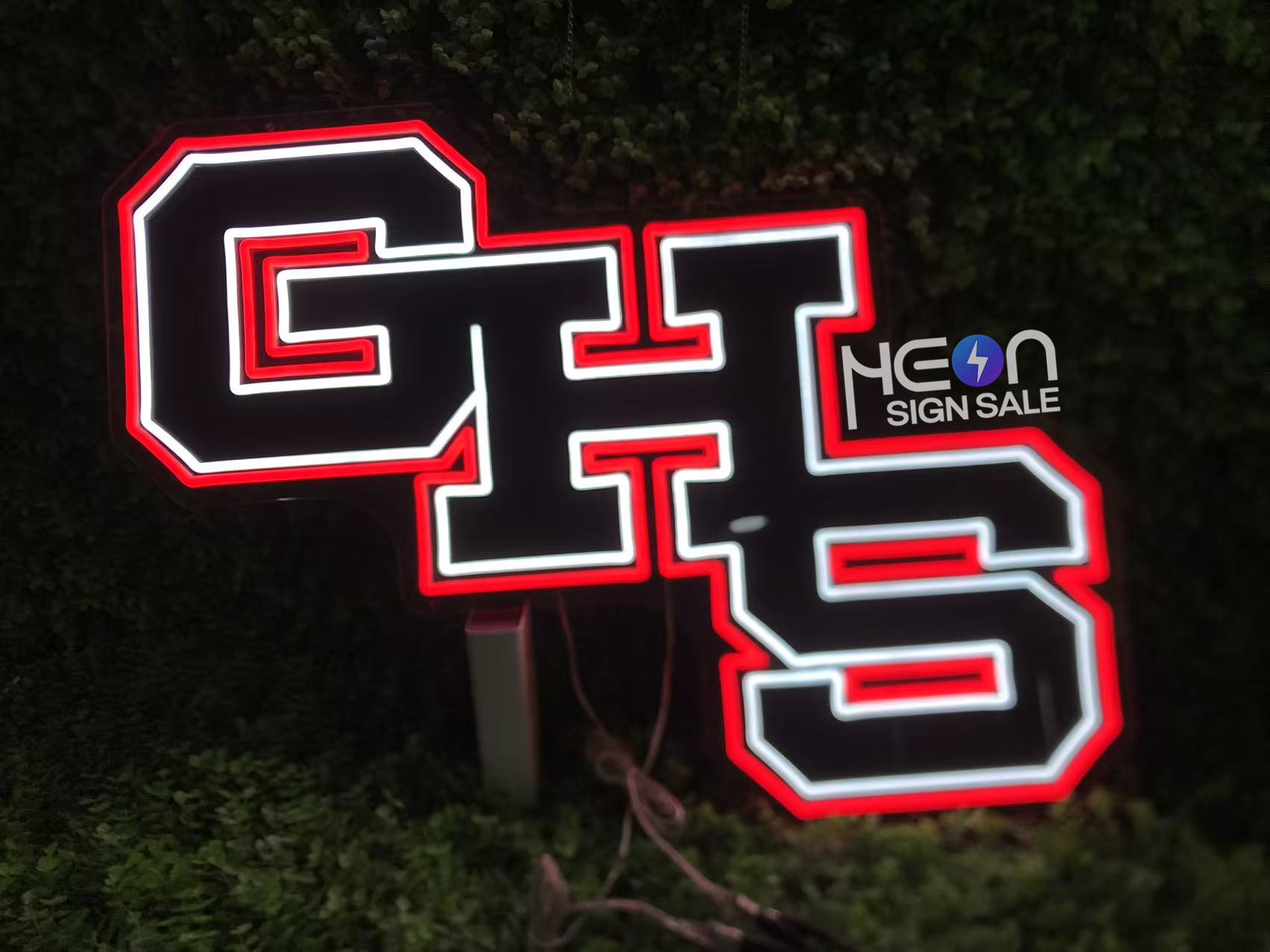 Finished black-background school initials illuminated in red and white
